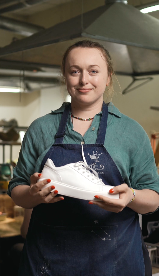 How Our Shoes Are Made - Image of Woman Holding a White Shoe